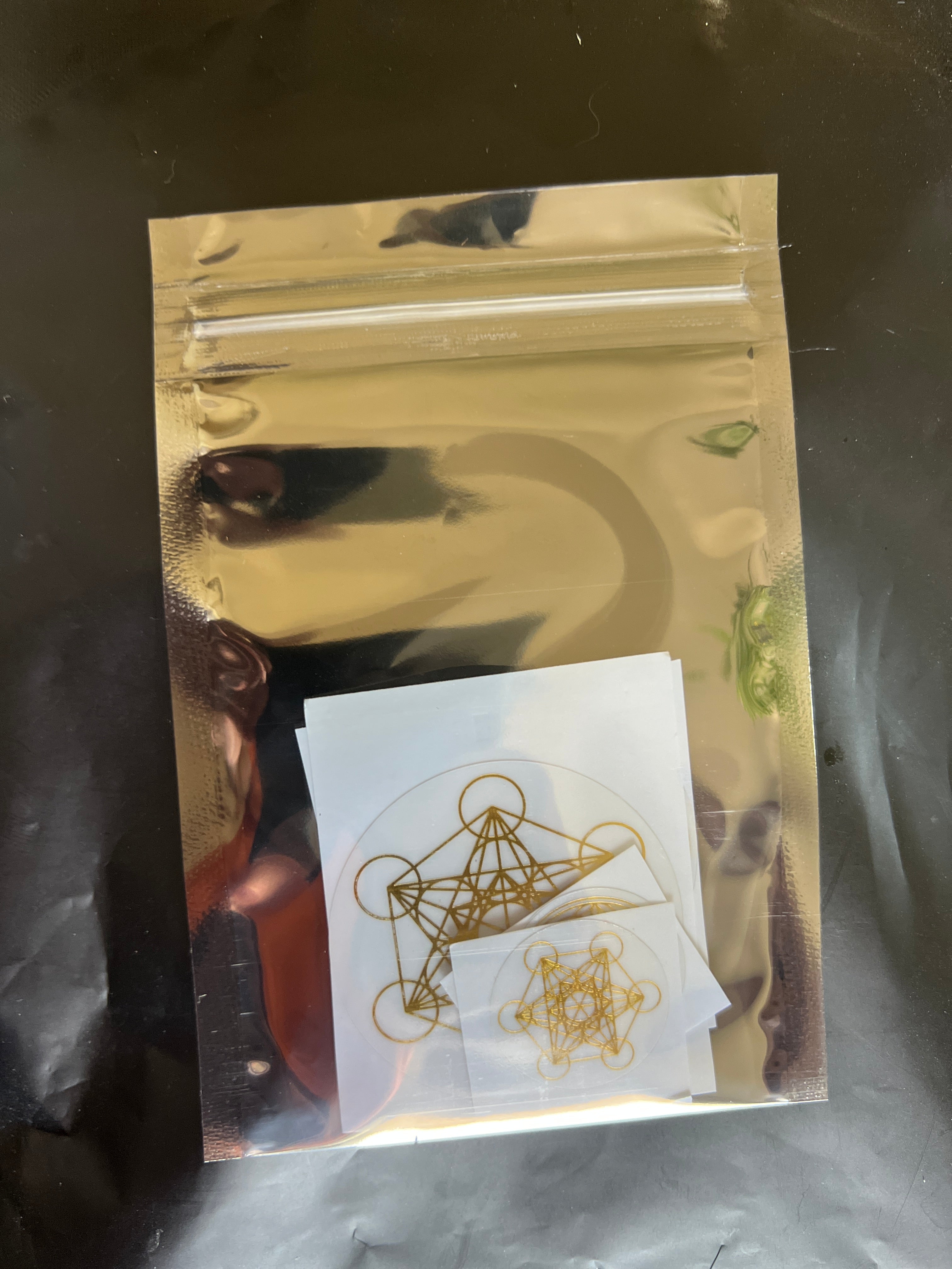 Sacred Ritual Oils Scalar Energetic Patches with gold geometric designs in resealable foil pouch